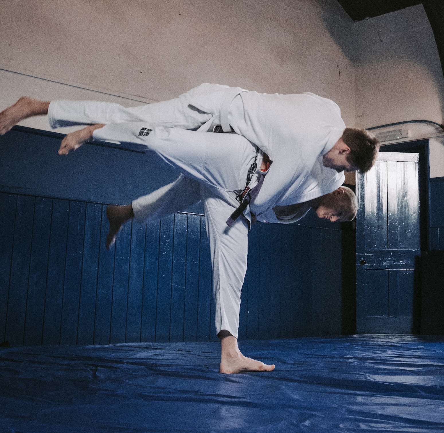 Coach demonstrating BJJ technique